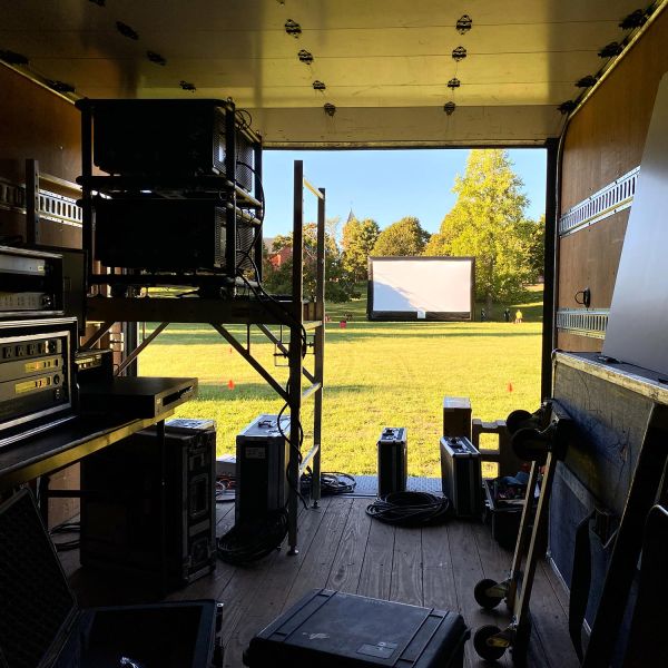 Outdoor movie screen viewed from inside a tech truck