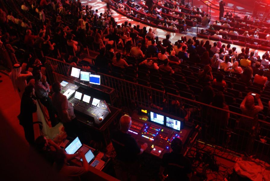 Sound and lighting control booth at a crowded event