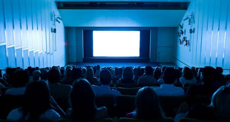Museum entrance with colorful banners and equestrian statue on green lawn
