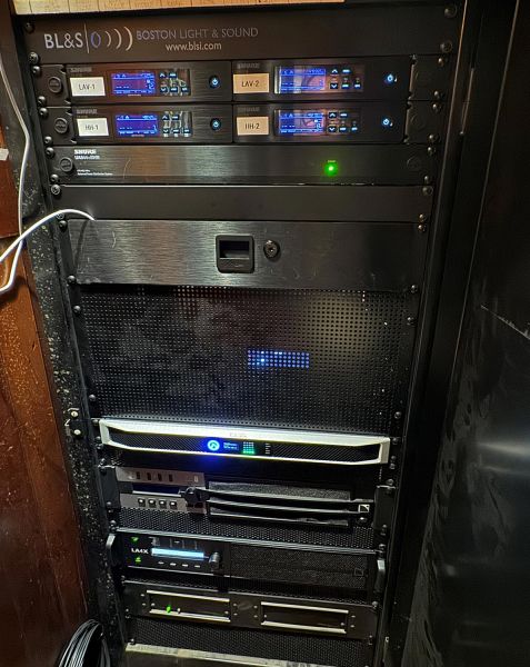 Audio equipment rack with wireless microphone receivers and power amplifiers