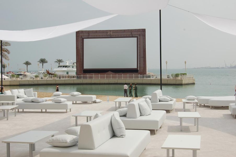 Lounge area facing a waterfront movie screen