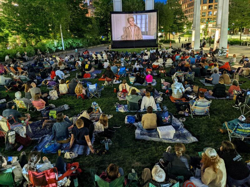 Crowd watching classic film at night during outdoor movie screening