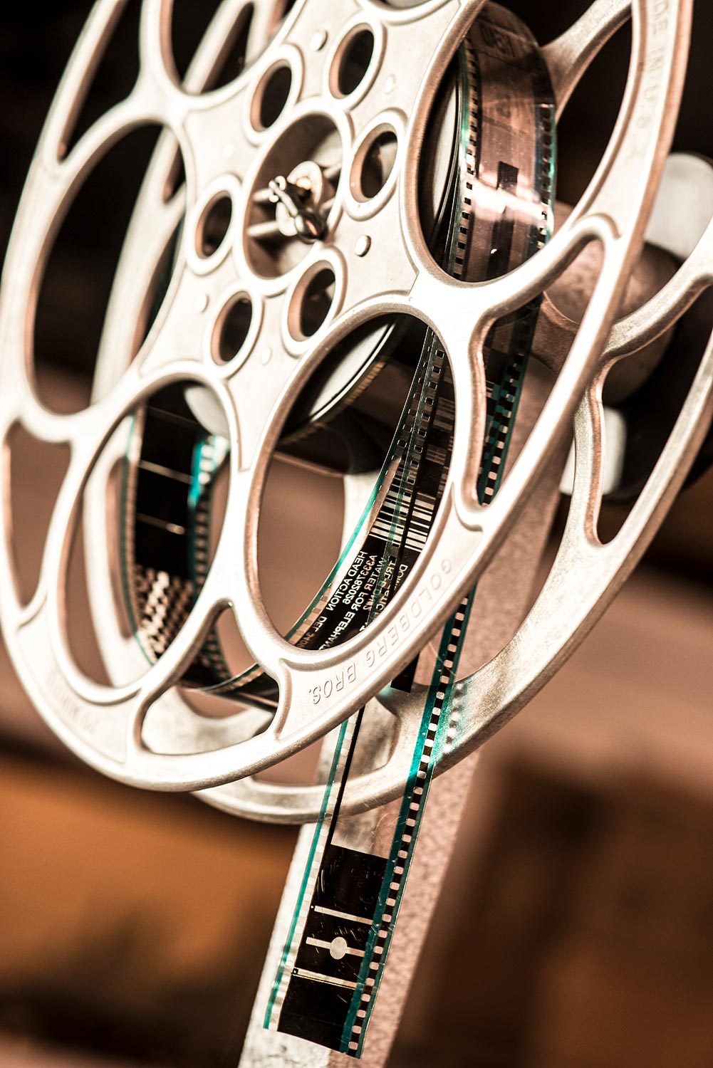 Close-up of film strip feeding through a metal reel mechanism