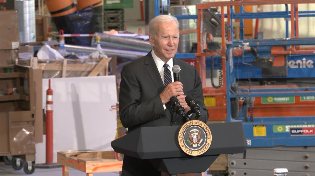 President Joe Biden delivering speech at indoor construction site